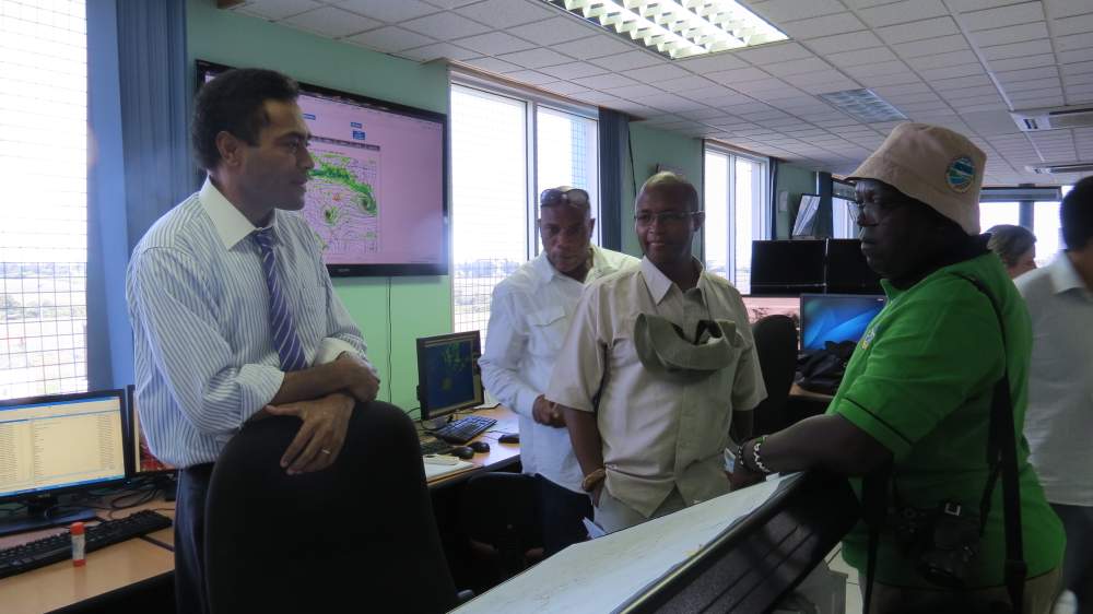 Meteorologists at the Fiji Meteorological Service in Nadi, Fiji, discuss climate and weather technologies and patterns with representatives from Jamaica and Kenya. 