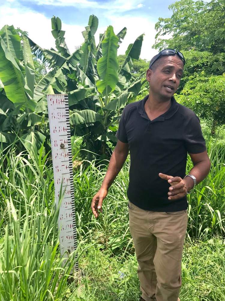 Vinesh Kumar points out flood lines at the Nadi Town bridge to delegates. 