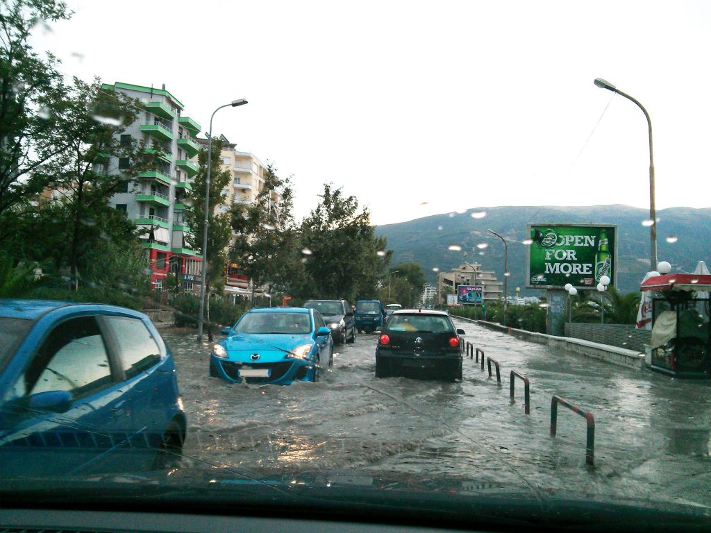 Vlora, Albania - August 10 2013: Cars driving through a flooded street after a summer flash flood