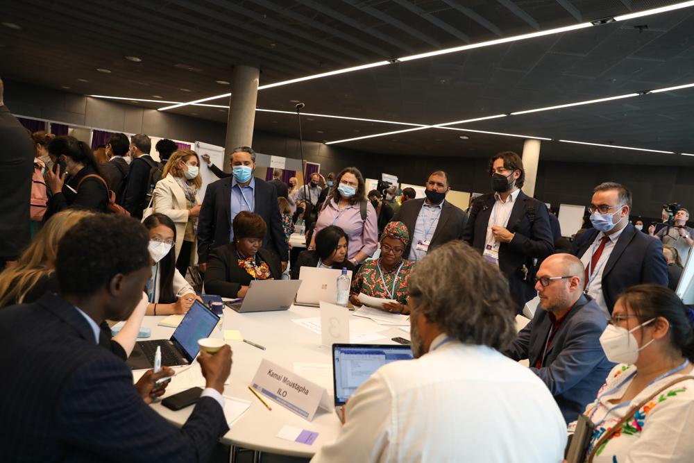 Participants at World Café tables discussing case studies, best practices, challenges, and solutions regarding implementing the Paris Agreement and meeting the long-term goals. (Photo by IISD/ENB | Kiara Worth)
