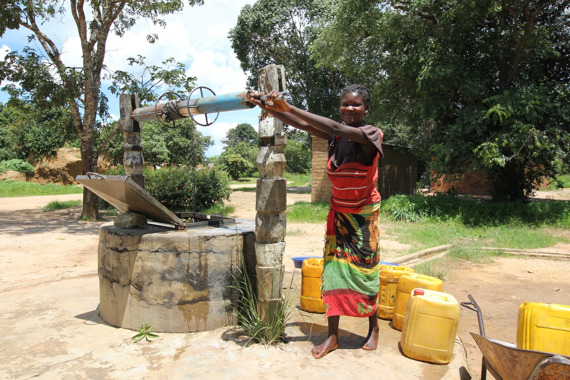 Mwinilunga, Zambia - December 8th, 2012: Young Woman at the water well in Africa