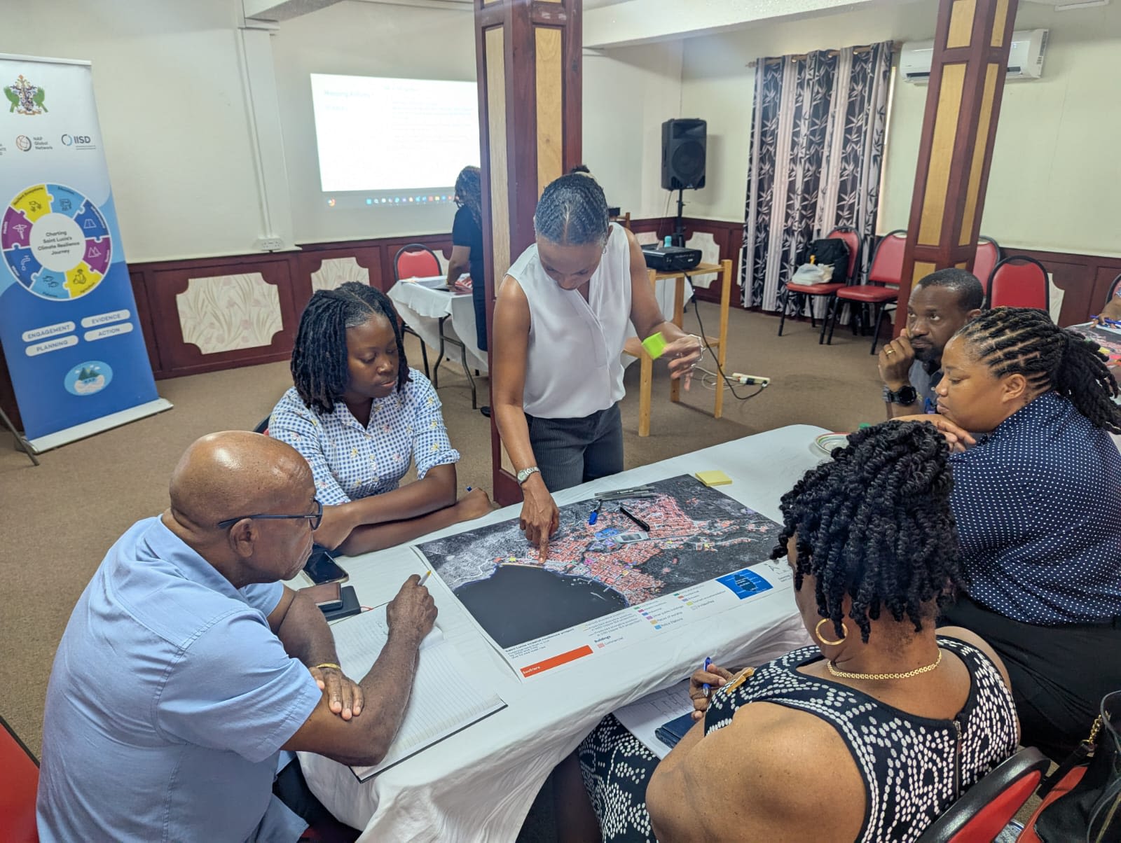 Participants engaging in discussions around coastal climate hazards and their implications. (Saint Lucia)